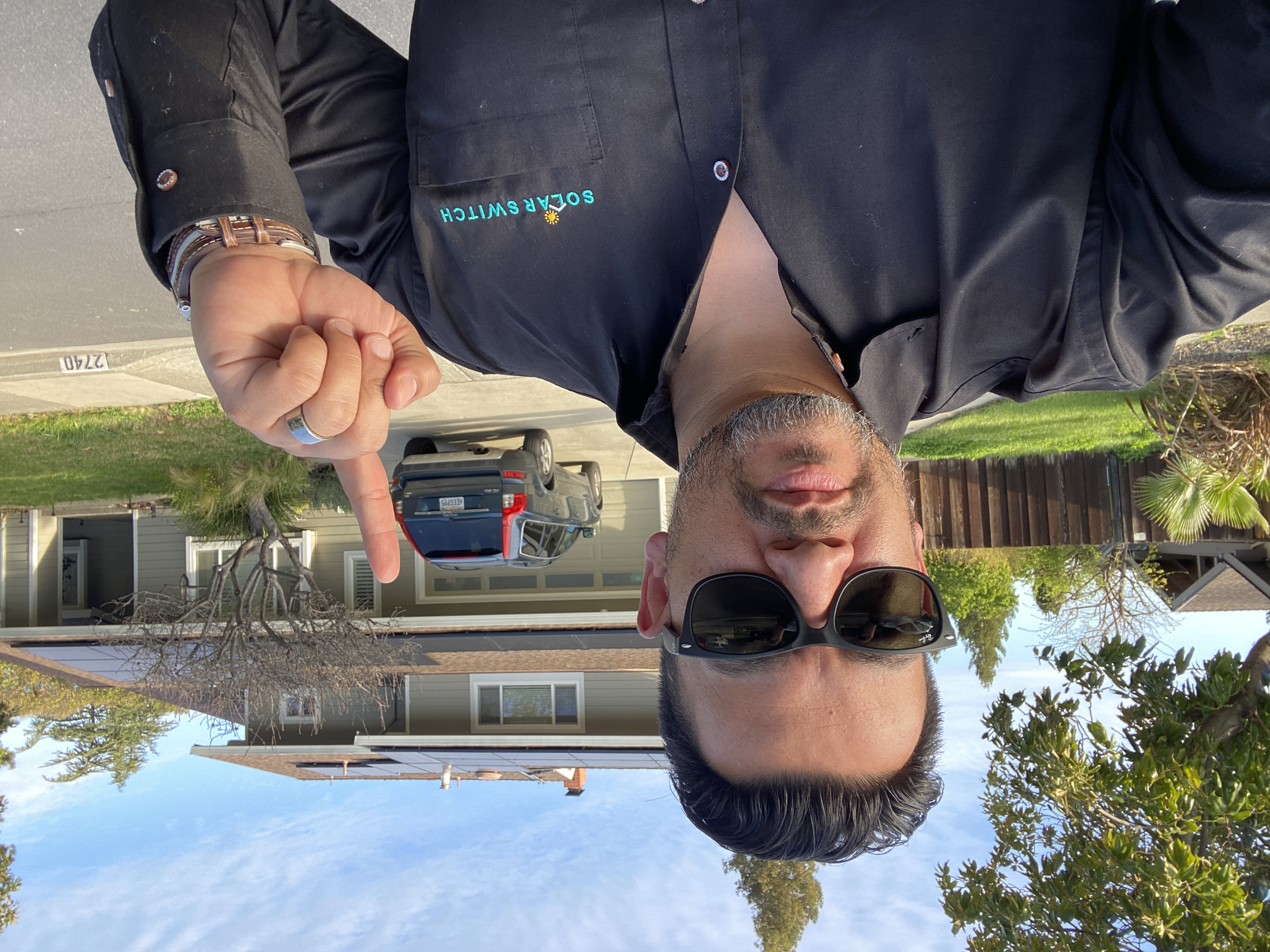Solar consultant pointing at completed installation