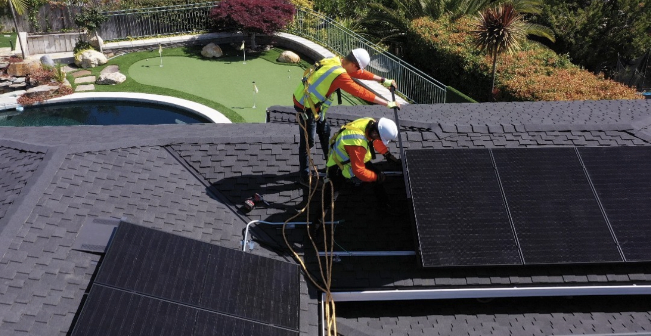 Installation crew working on rooftop solar system