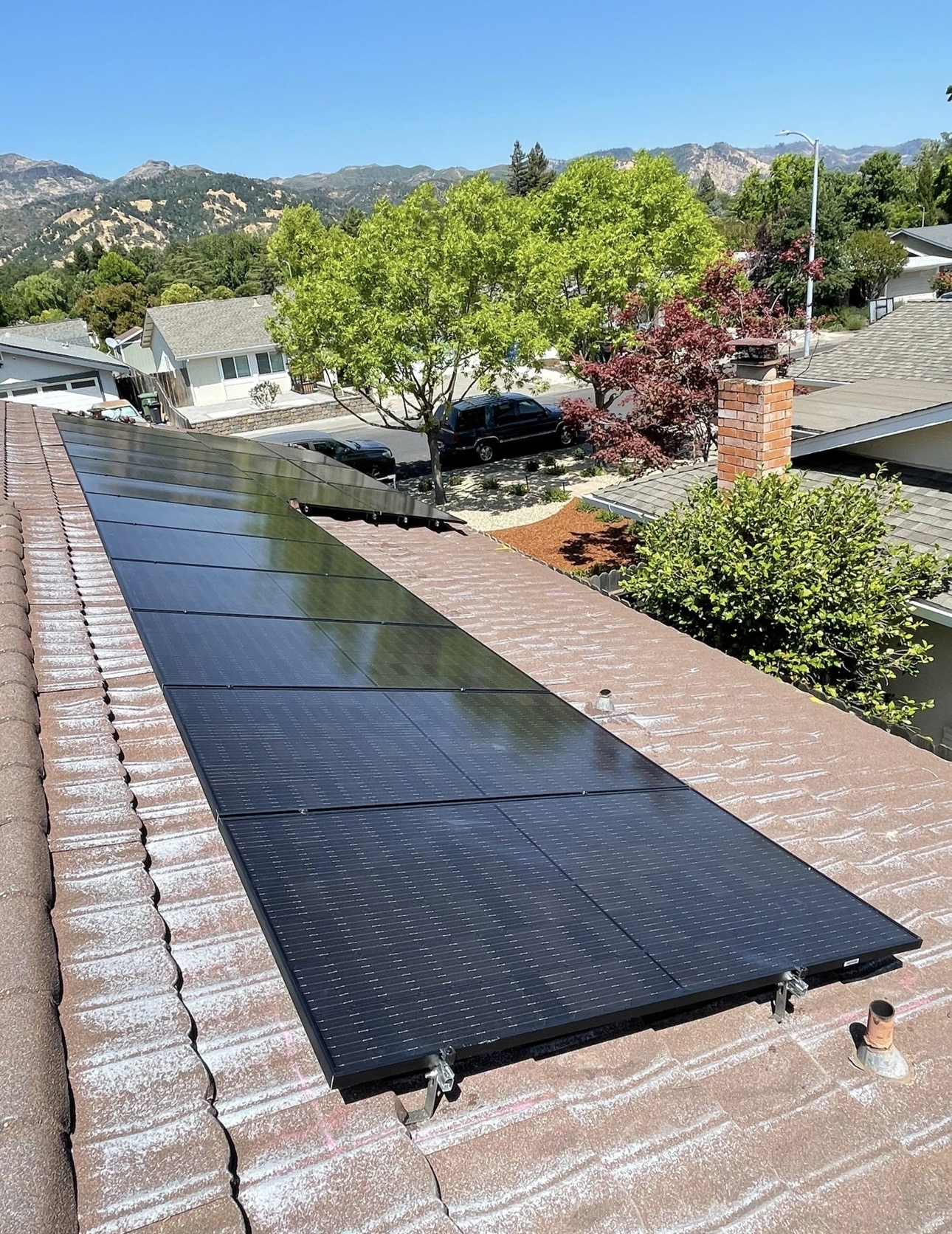 Solar panels on tile roof with mountain views