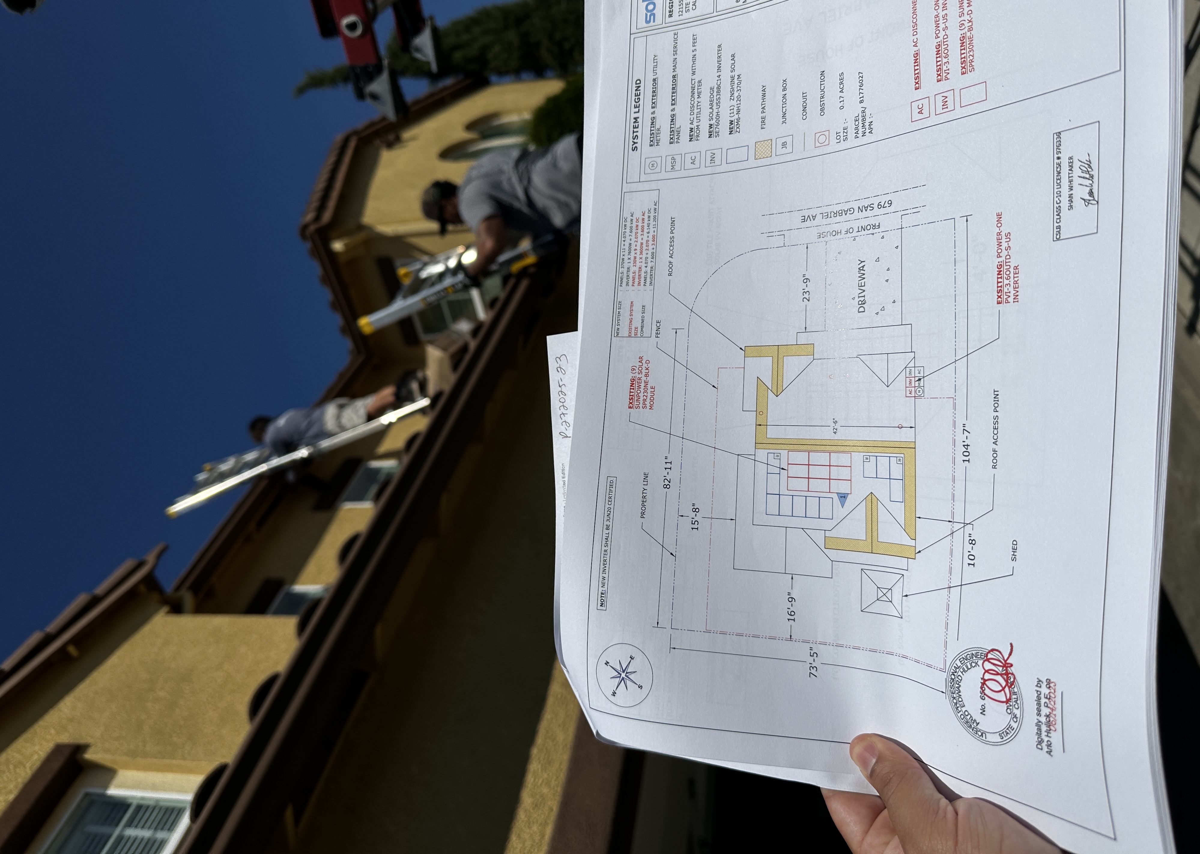 Consultant holding solar system plans at job site